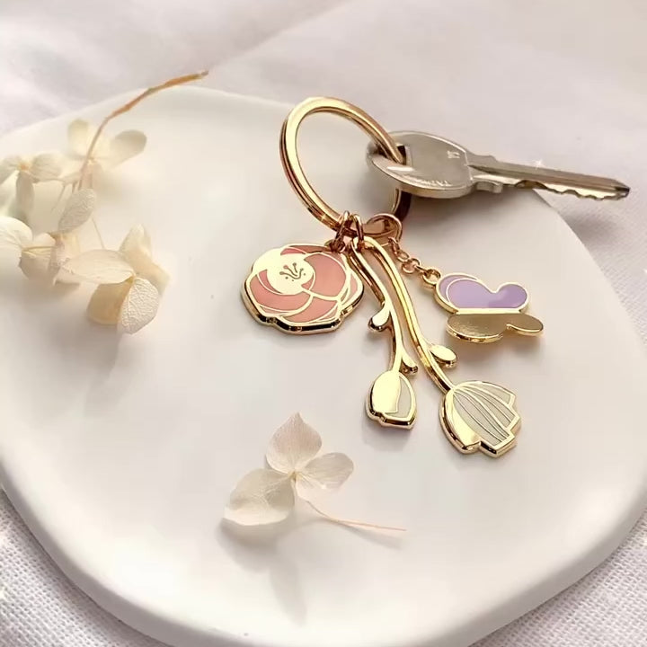 Minimal Garden Keychain featuring rose, peony, and butterfly charms on a stylish display.