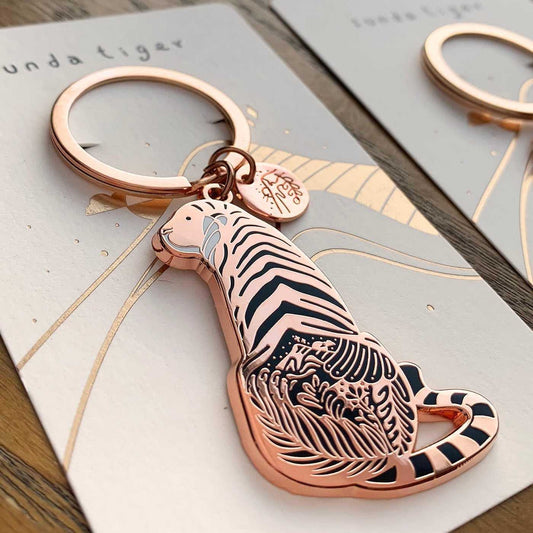 Sunda Tiger enamel keychain featuring delicate habitat art and a round tag showcasing its name.