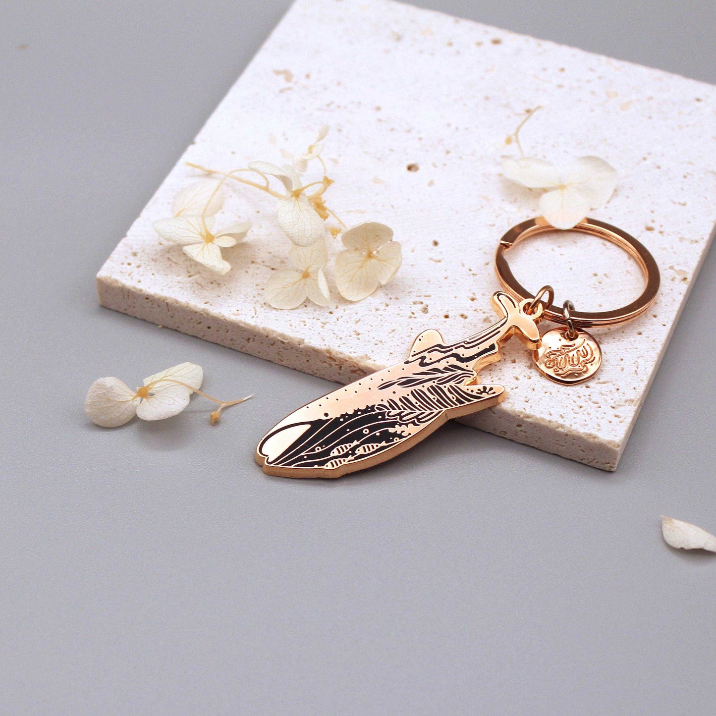 Whale Shark enamel keychain on a textured surface, showcasing delicate habitat art and organic-shaped round tag.