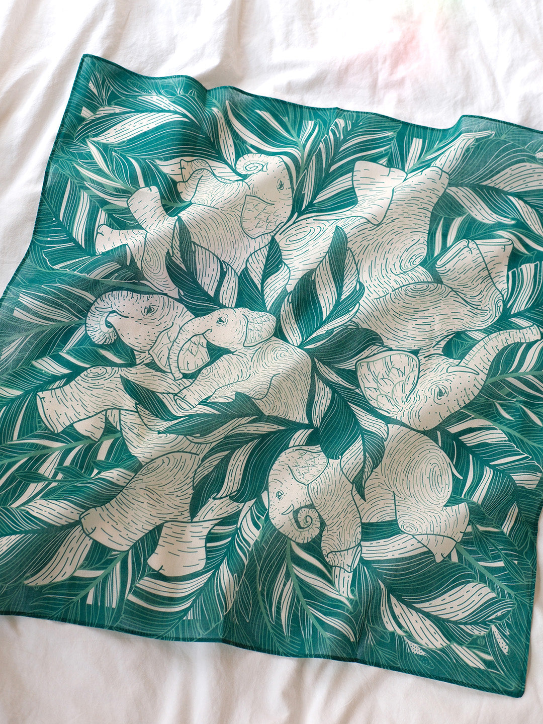 Elephant Siesta bandana scarf featuring illustrated elephants in a lush green jungle design.