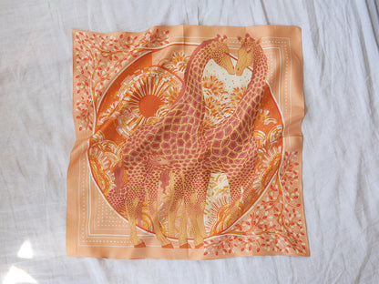Decorative scarf with giraffe design on a white background