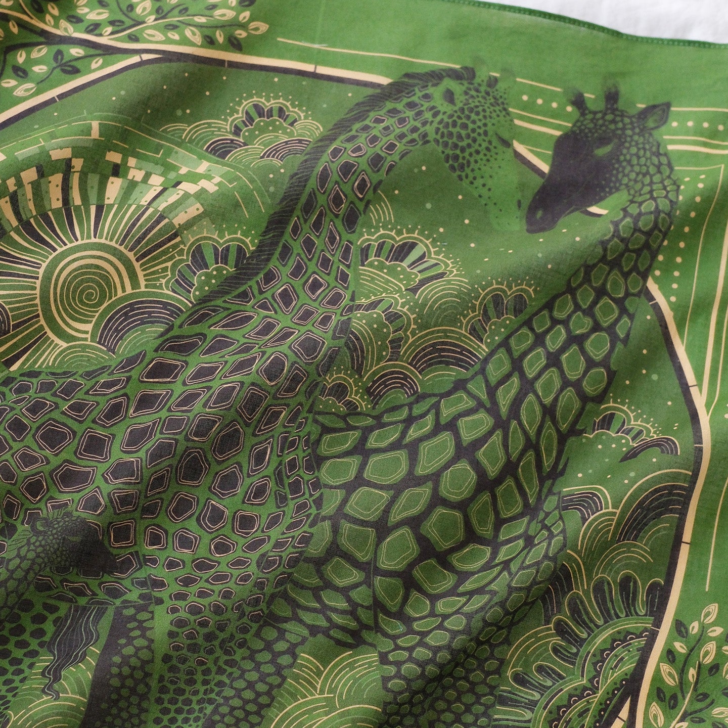 Olive green bandana scarf featuring a Giraffe family design with Savanna grassland art.
