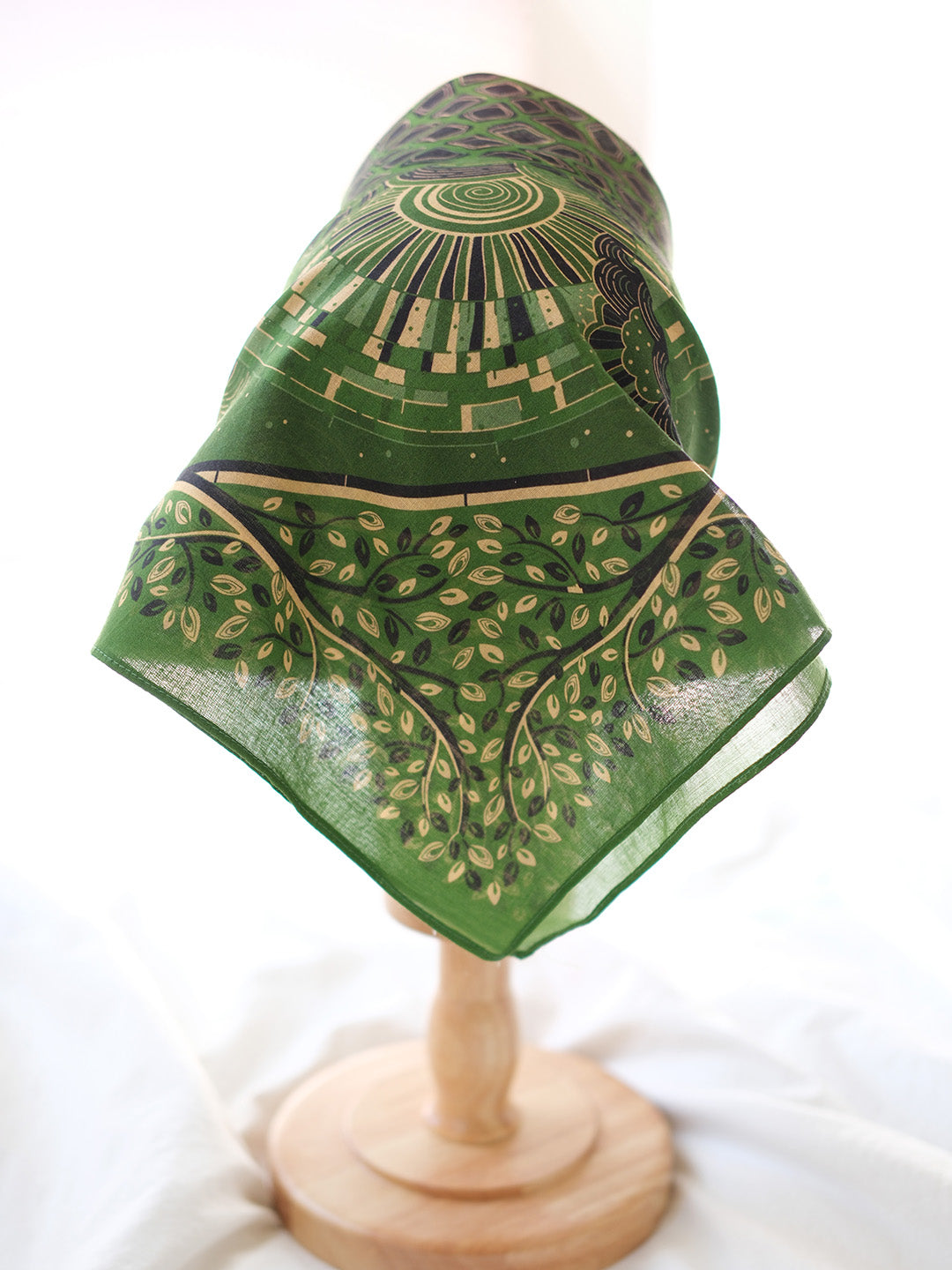 Olive green bandana scarf featuring intricate tree and sun designs, perfect for fashion and decoration.