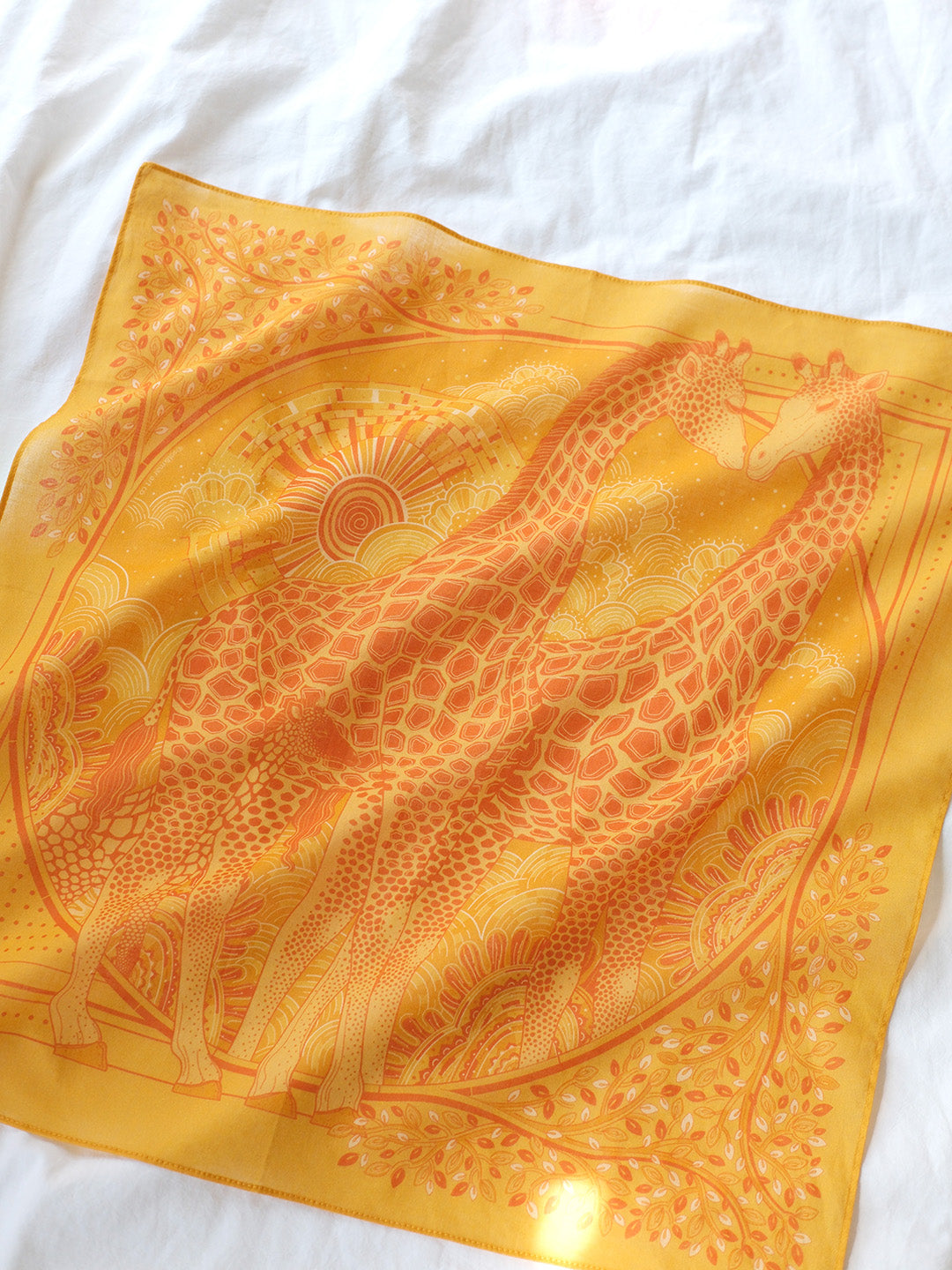 Giraffe family illustration on a golden yellow cotton bandana scarf, perfect for hair accessories or decor.