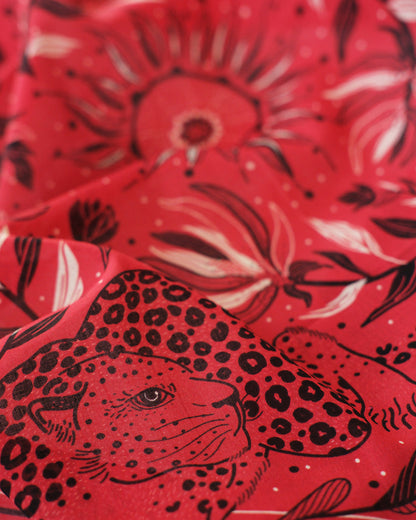Red fabric with black leopard and floral pattern