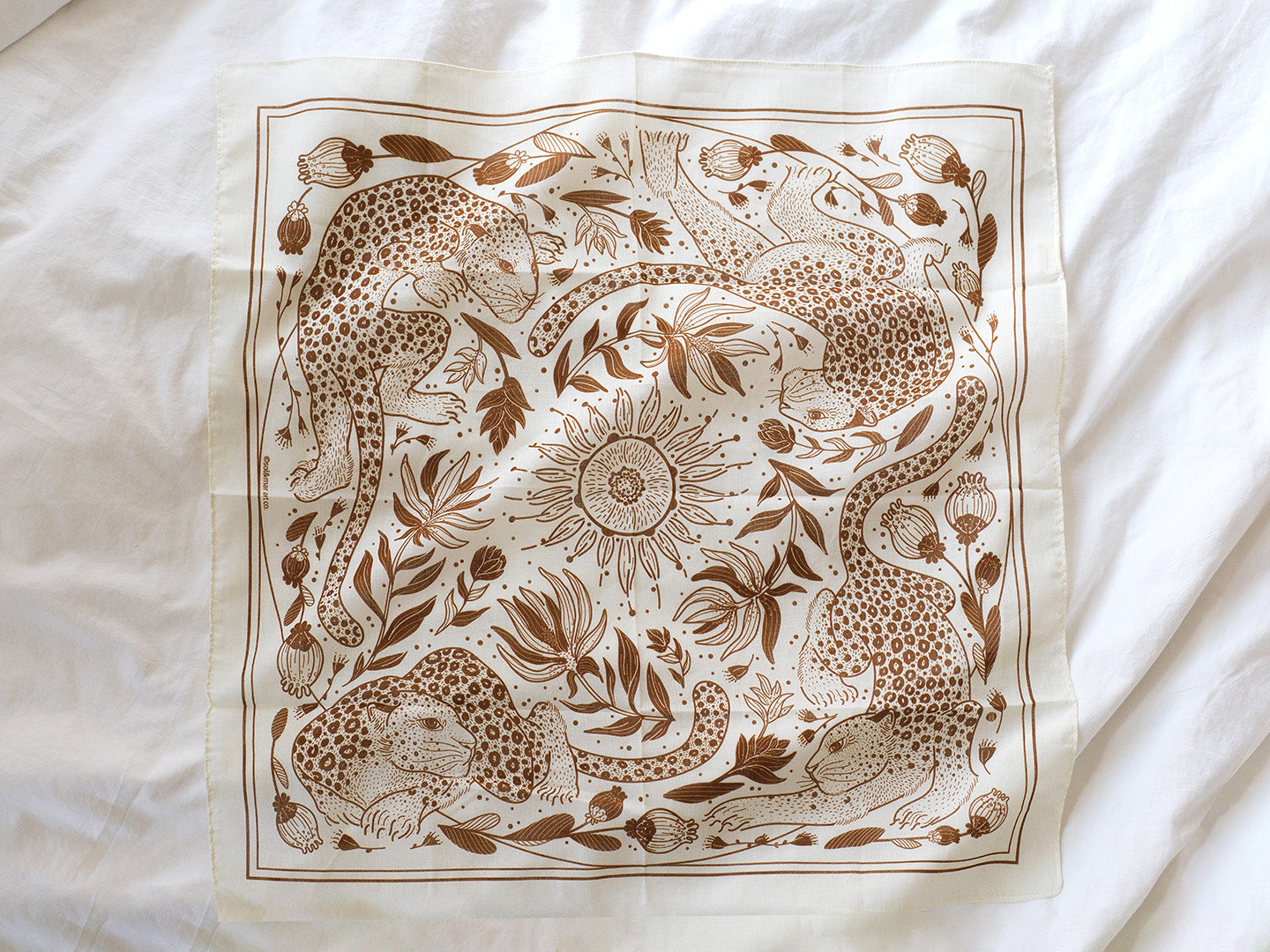 Leopard and the Sun illustrated bandana scarf in off-white with detailed line art design.