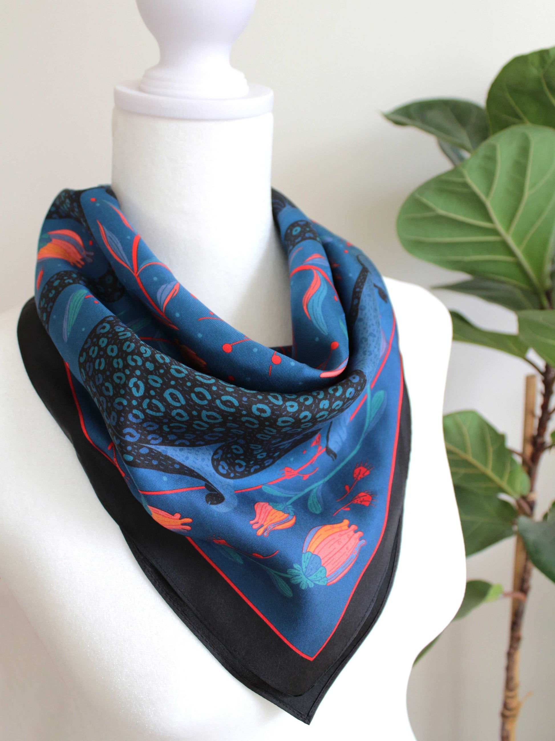 Leopard and the Sun silk twill scarf displayed on a mannequin with tropical floral design, 21x21 inches.