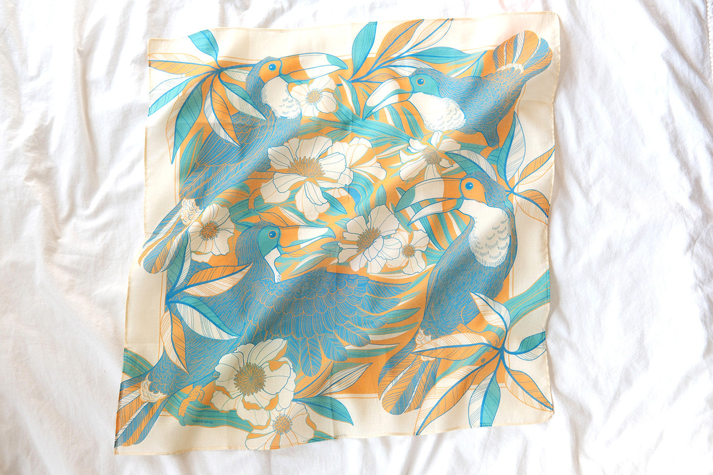 Toucan in Floral Jungle Bandana Scarf, yellow and blue design with tropical flowers and leaves, perfect for hair or pet accessories.