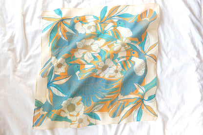 Toucan in Floral Jungle Bandana Scarf, yellow and blue design with tropical flowers and leaves, perfect for hair or pet accessories.