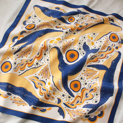 Whale and ocean design silk twill scarf featuring colorful humpback whales on a white background.