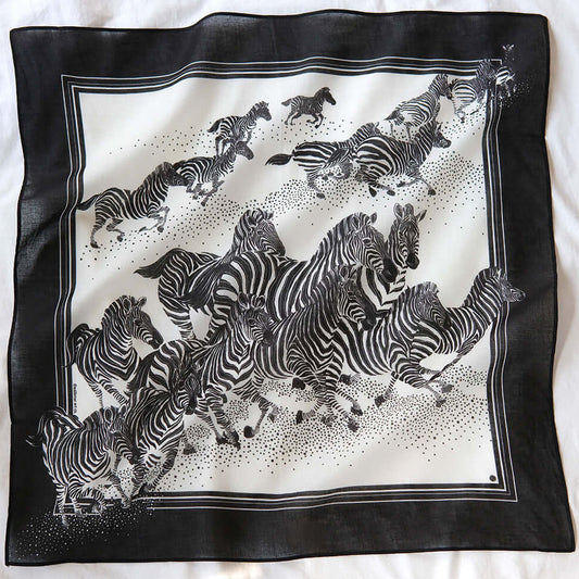 Black and white bandana scarf featuring a herd of zebras running, perfect as a fashion accessory or pet scarf.