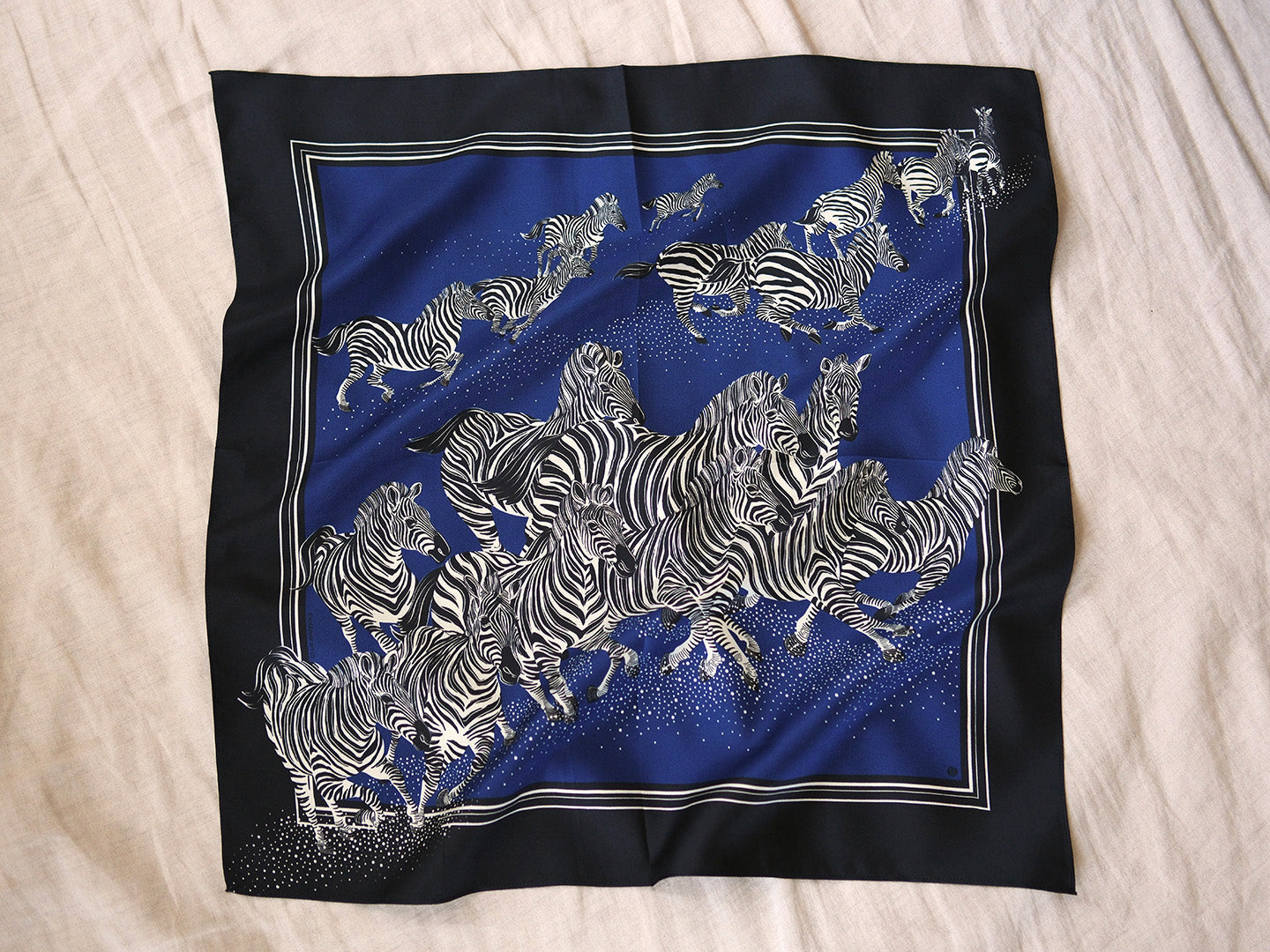 Silk scarf with zebra pattern on a blue background
