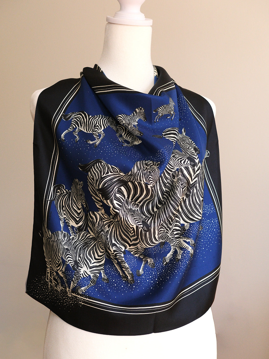 Scarf with zebra design on a mannequin against a beige background