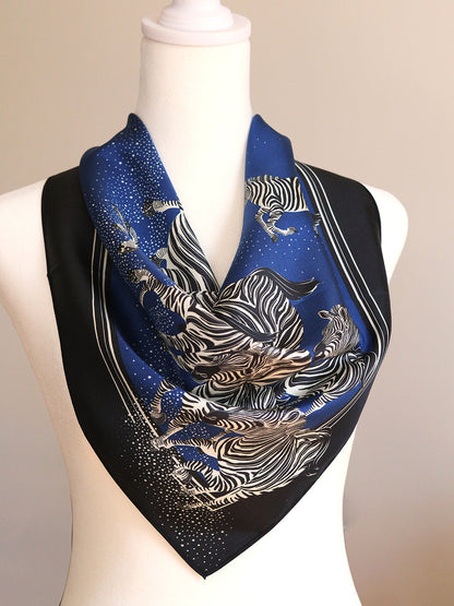Blue scarf with zebra pattern on a mannequin against a beige background